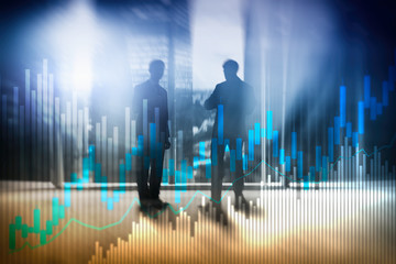 Stock trading candlestick chart and diagrams on blurred office center background.