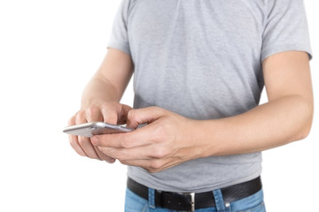 A young man holding a smartphone and touching its screen, isolated on white background