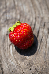 Close-up of strawberry on a wooden plank, shot with a low depth of field