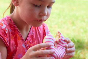 The child is eating a donut.