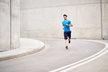 Athletic man jogging in the city during outdoors workout session