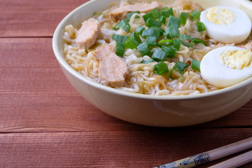 Chinese chicken soup. Cooked in a wok.Wooden background.