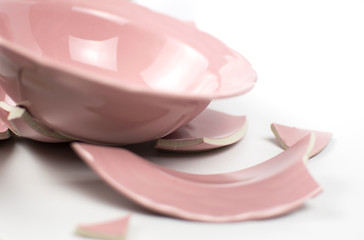 Broken and whole plate on a light background.