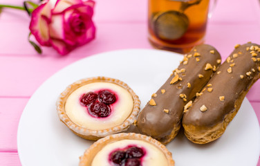 A set of different cakes on a white plate.