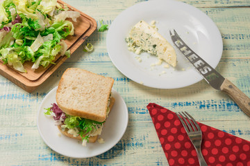 Vegetarian sandwich with salad and blue cheese on a wooden background. Healthy Diet