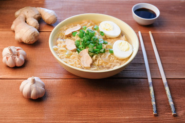 Chinese chicken soup. Cooked in a wok.Wooden background.