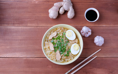 Chinese chicken soup. Cooked in a wok.Wooden background.