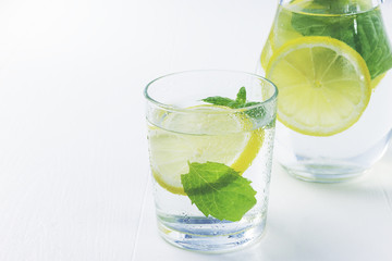 Lemonade with fresh lemon. Lemon water.