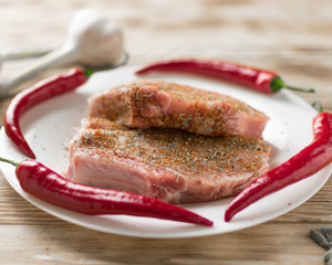 Raw pork ribs with hot red pepper. Preparation of meat for grilling.