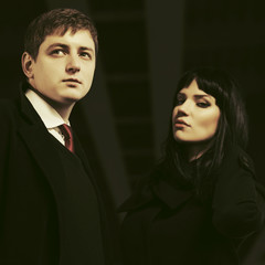 Young fashion business couple walking in city street