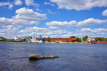 Fototapeta na wymiar landscape, view of the old cargo port, rusty barge