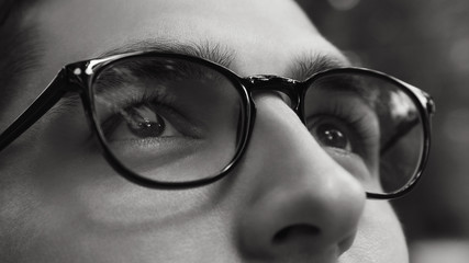 Close-up of man wearing glasses. Black and white life without sight. Healthy sight concept.