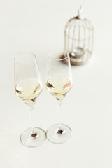 two glasses of champagne on a table with a white tablecloth and