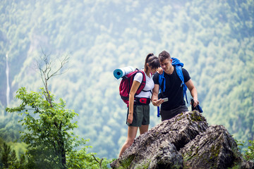 Hikers using smartphone while hiking