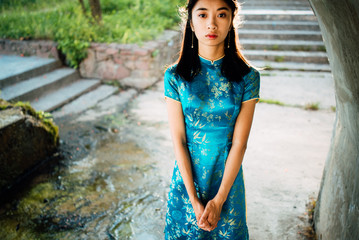 Beautiful young Asian girl outdoors, Ao dai - famous traditional costume for a woman in Vietnam