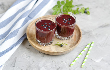 Delicious wild blueberry smoothie milk yogurt ice cream gray background summer drink concept