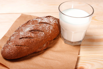 Bread and milk on wooden background