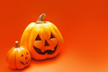 Happy Halloween. Two Jack-o-lantern on orange background
