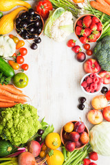 Fresh summer fruits vegetables berries, apples cherries peaches strawberries cabbage broccoli cauliflower squash tomatoes carrots spring onions beans beetroot, copy space, top view, selective focus