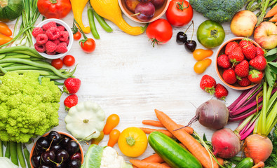 Colourful farm produce, fruits vegetables berries, apples cherries peaches strawberries cabbage broccoli cauliflower squash tomatoes carrots spring onions beans beetroot, copy space, top view