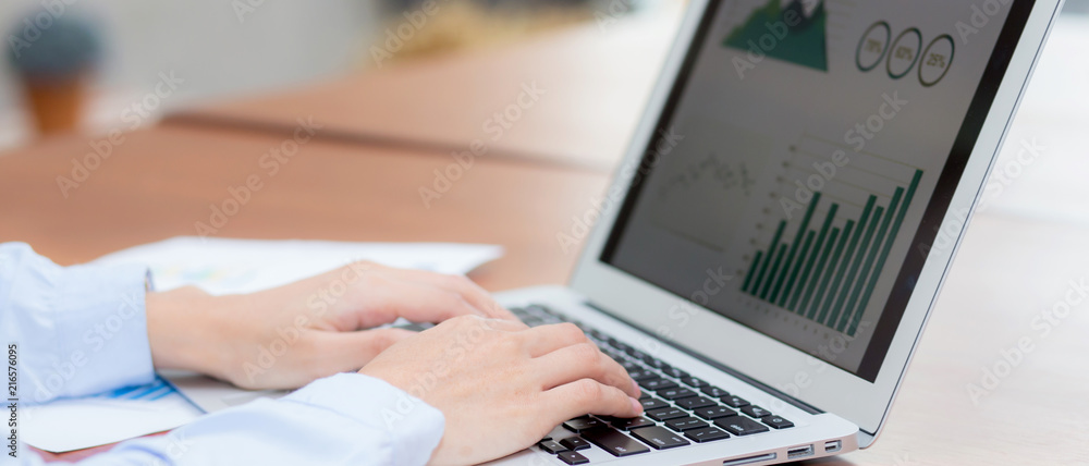 Poster closeup banner website work with finance analysis and planing data on laptop, typing and paper graph