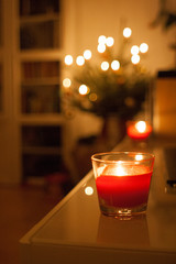 Red candles lighting a house in Christmas time
