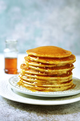 Stack of homemade delicious pancakes with maple syrup for a breakfast.
