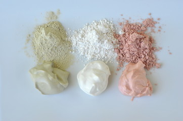 Deep cleansing cosmetic bentonite (montmorillonite) clay for beauty spa face mask, body detox and hair treatments. Clay and activated charcoal powder and mask in glass bowl.
