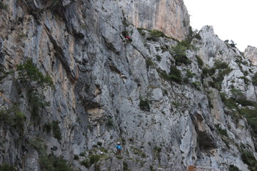 Rock climber in the spanish Pyrenees mountain range in the France border, traditional climbing with self-protection anchors and amazing place for rock climbing sports, Spain