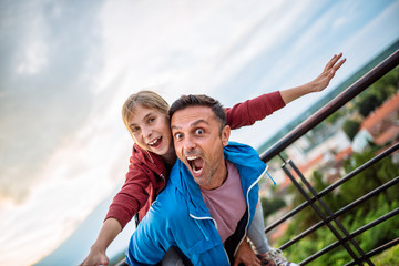 Father carrying daughter on his back