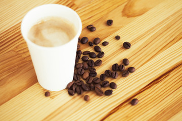 Good Morning. Coffee To Go. Coffee Cups With Cover and Coffee Beans on Wooden Table Backound