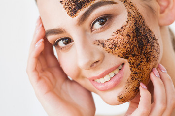 Face Skincare. Young Charming Girl Makes a Black Charcoal Mask on Her Face