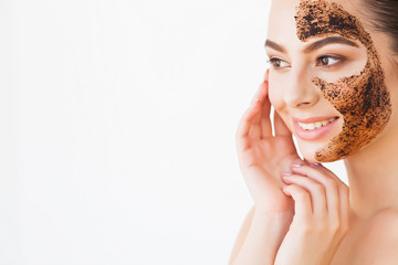 Face Skincare. Young Charming Girl Makes a Black Charcoal Mask on Her Face