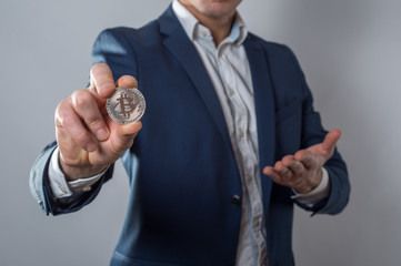 Golden Bitcoin in a man hand, Digitall symbol of a new virtual currency
