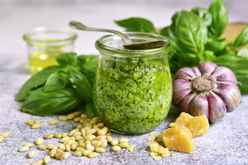 Homemade sauce pesto in a vintage jar with ingredients for making.