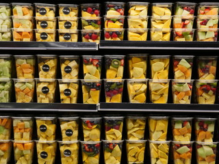 fruits in plastic containers orgenized in store