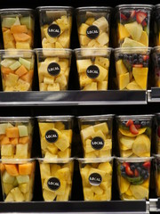 local fruits in plastic containers in store
