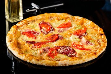 Tasty Italian pizza on a dark