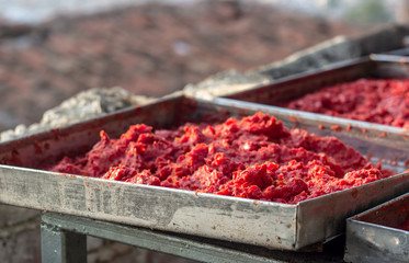 Traditional handmade tomato paste making process shot under open air