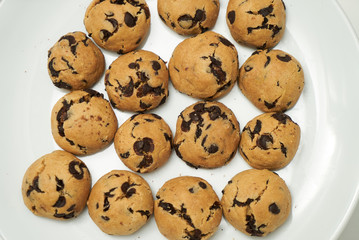 Cookies and sweet biscuits on white plate background, top view 