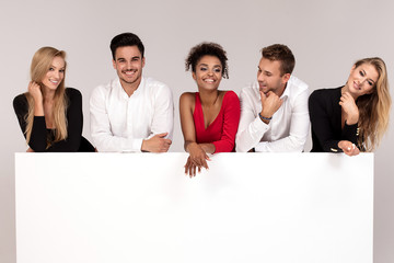 Group of elegant people with empty white board.