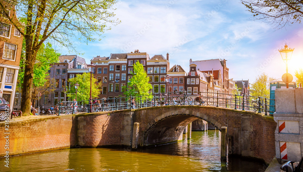 Wall mural Traditional old buildings and boats in Amsterdam, Netherlands. Canals of Amsterdam.