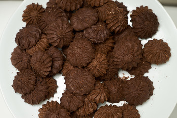 Cookies and sweet biscuits on white plate background, top view 