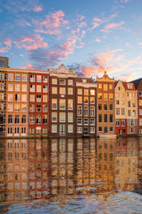 Naklejka premium Traditional old buildings and boats in Amsterdam, Netherlands. Canals of Amsterdam.