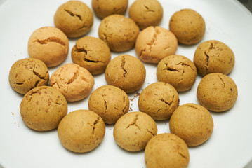 Cookies and sweet biscuits on white plate background, top view 