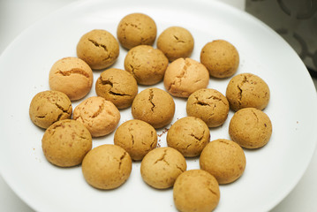Cookies and sweet biscuits on white plate background, top view 