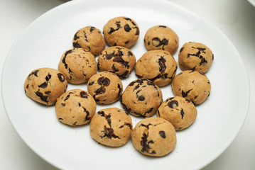 Cookies and sweet biscuits on white plate background, top view 
