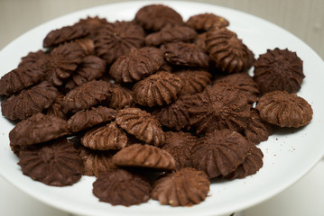 Cookies and sweet biscuits on white plate background, top view 