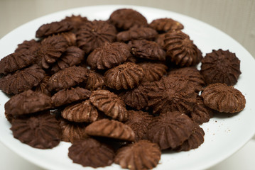 Cookies and sweet biscuits on white plate background, top view 