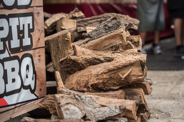 Mesquite wood logs stacked neatly and ready for the smoker grill for bareque flavored meat.